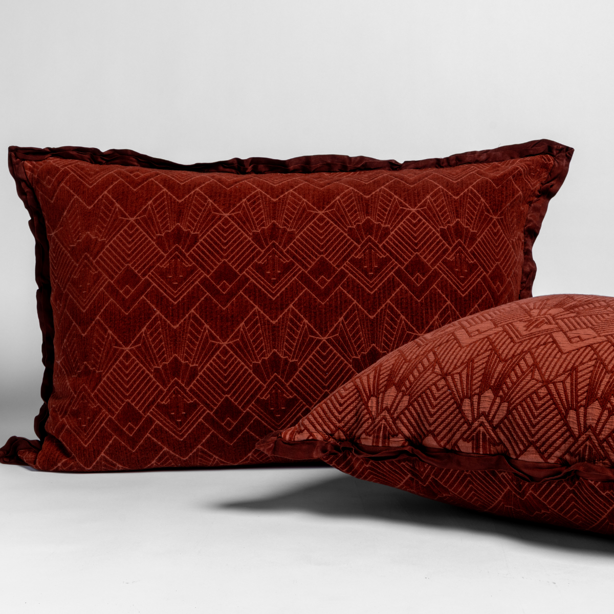 Bella Notte Trettino sham in Autumn, geometric velvet pattern with flange trim, paired cushion foreground.