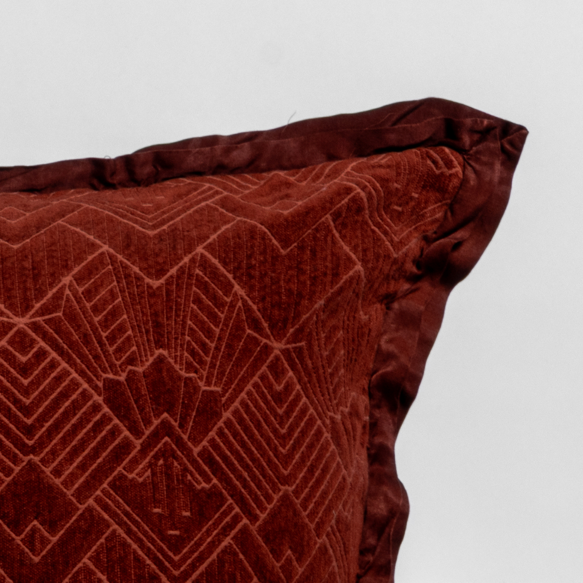 Close-up of Autumn Bella Notte Trettino sham corner, showing geometric velvet pattern and trim detail.