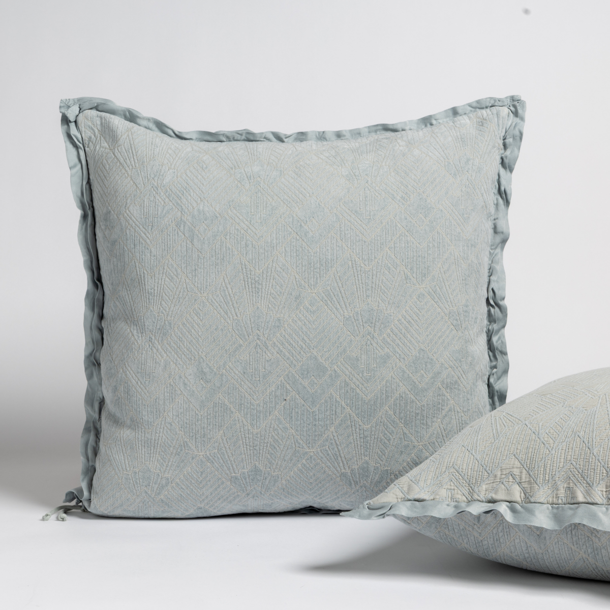 Bella Notte Trettino sham in Cloud, showing ruffled edge trim and quilted diamond pattern detail.