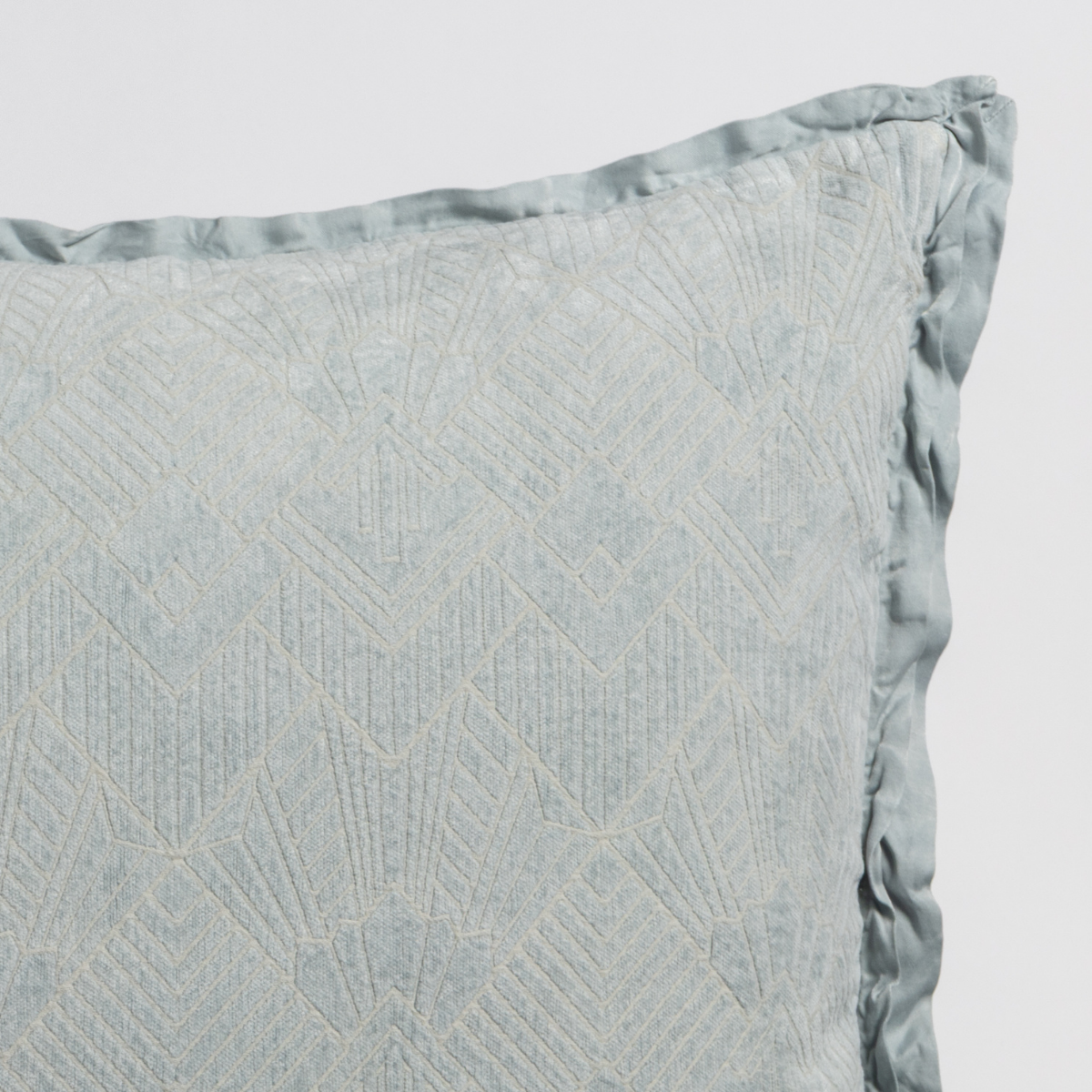 Close-up of Cloud Bella Notte Trettino throw pillow showing geometric embroidery and satin trim edge.