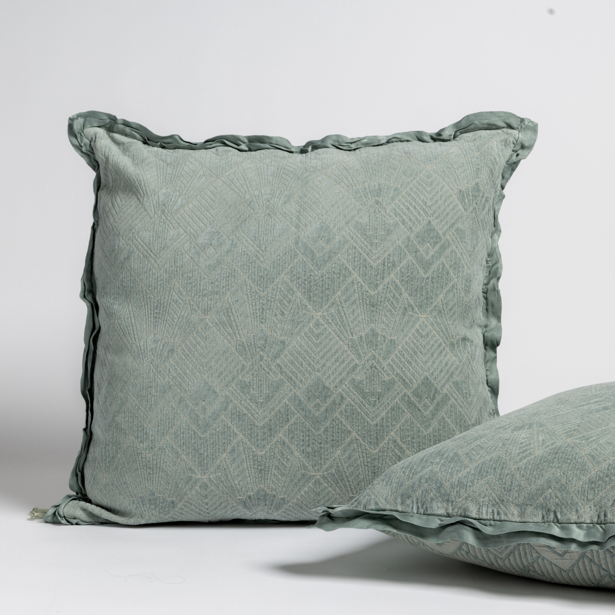 Close-up of Bella Notte Trettino sham in Eucalyptus with diamond jacquard and ruffled trim.
