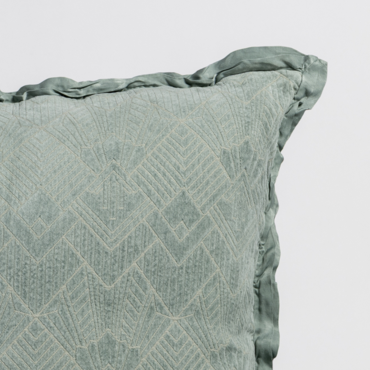Close-up of Eucalyptus sham corner showing diamond chevron texture and ruffled silk edge.