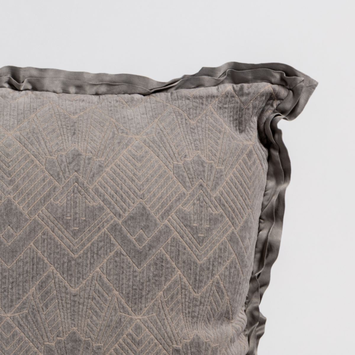 Close-up of Fog Bella Notte Trettino throw pillow showing chevron texture and satin ruffle trim.