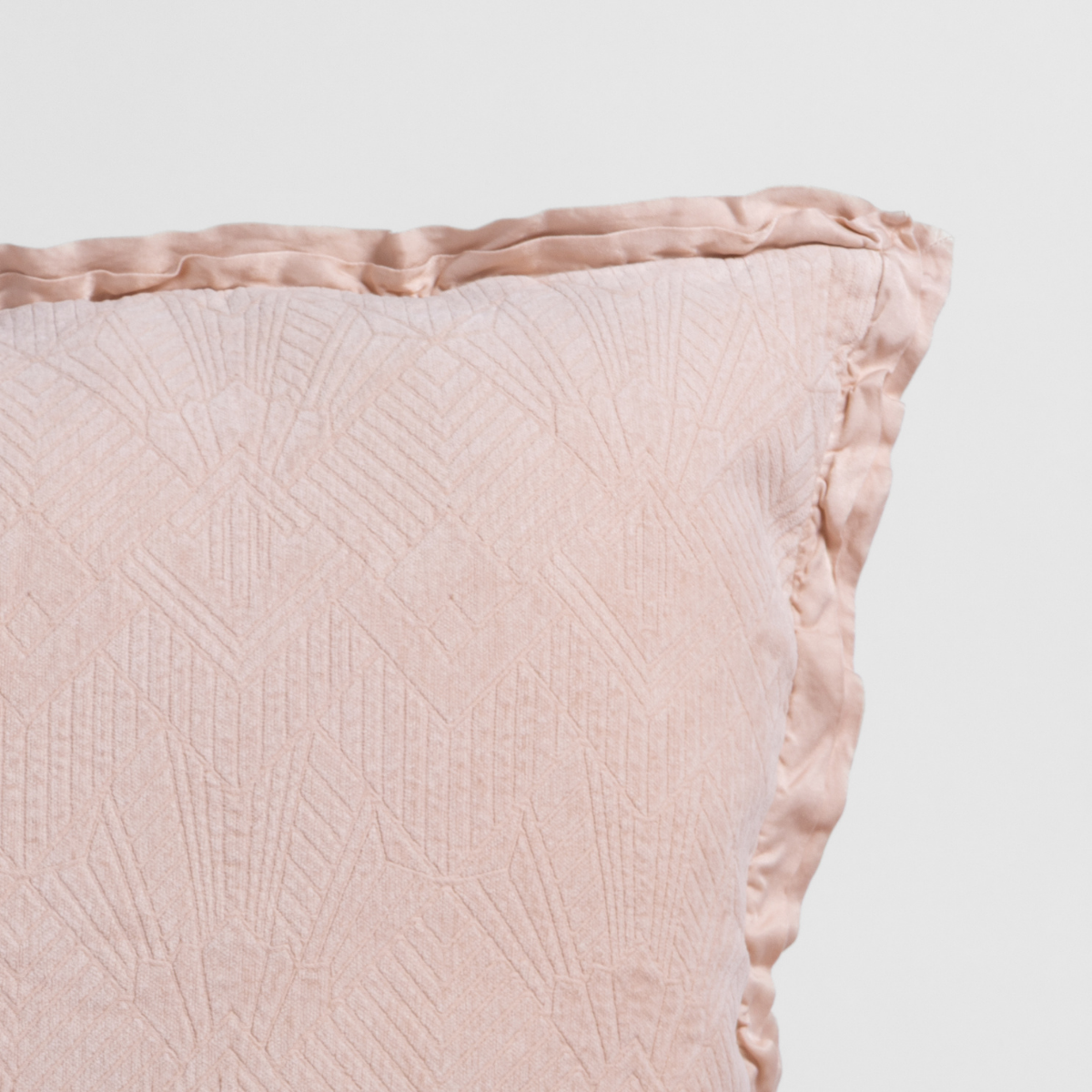 Close-up of Pearl Bella Notte Trettino throw pillow showing quilted pattern and satin trim detail.