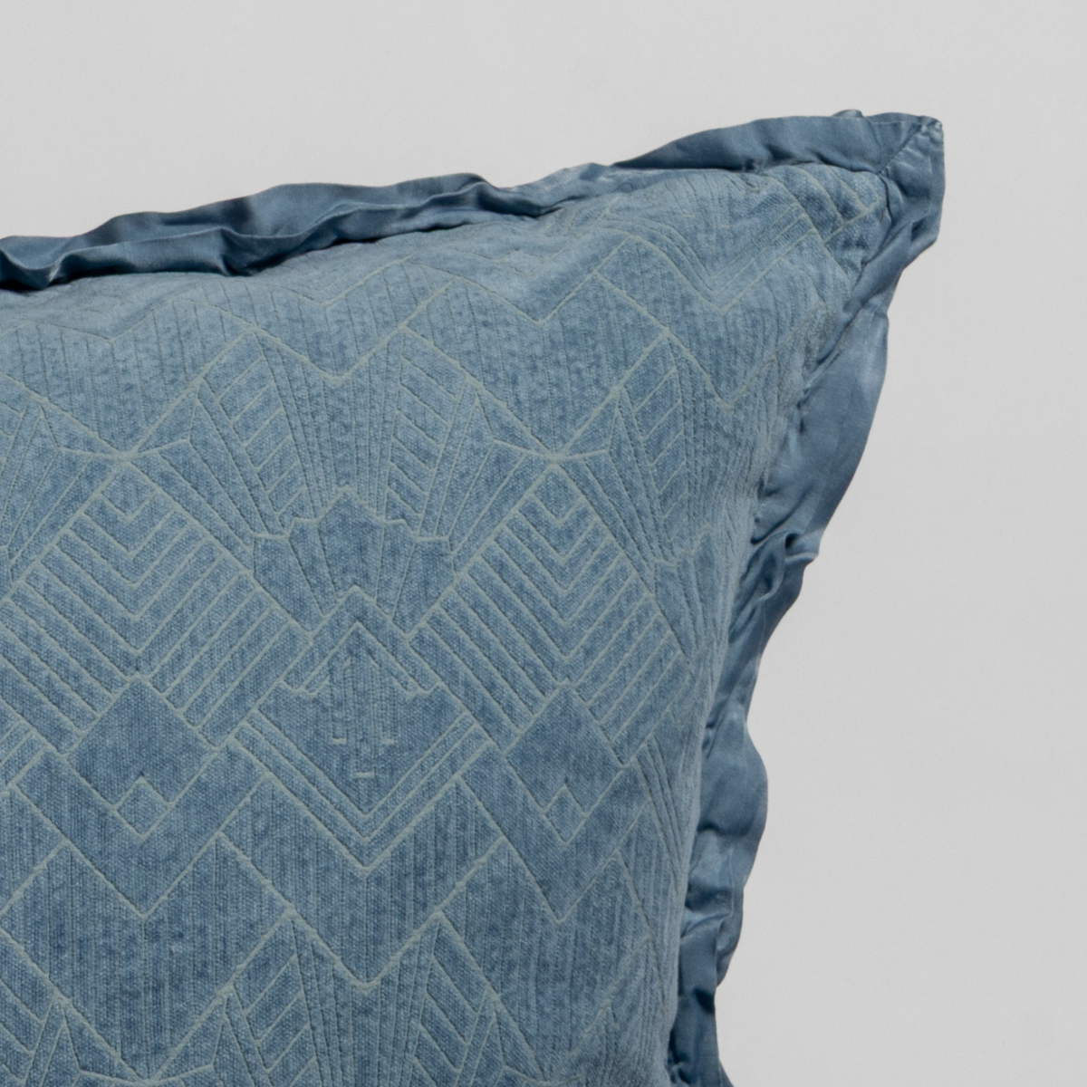 Close-up of Tahoe Blue sham corner showing geometric diamond stitching and ruffled edge trim.