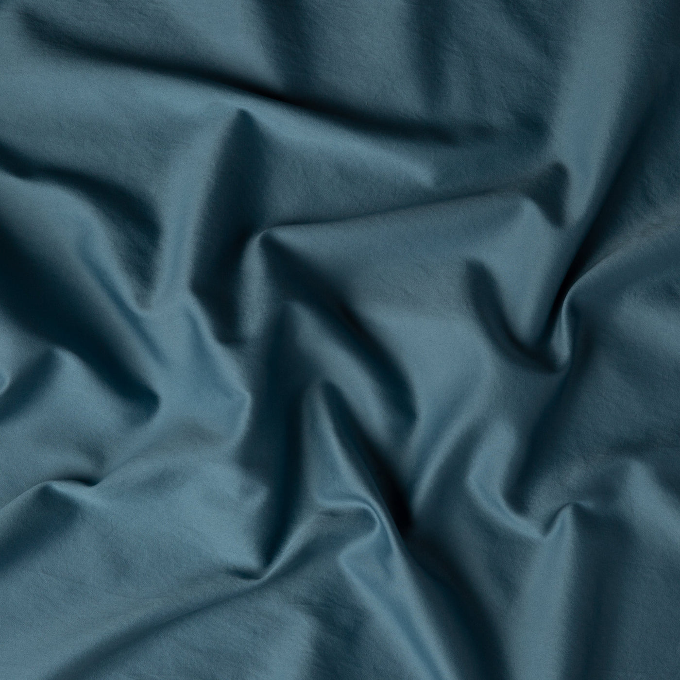 Close-up of Cenote Bria duvet cover fabric with soft, flowing drape.