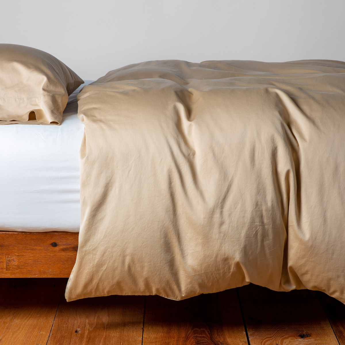 Honeycomb duvet cover draped loosely over bed, shown with matching pillowcase on wood frame.