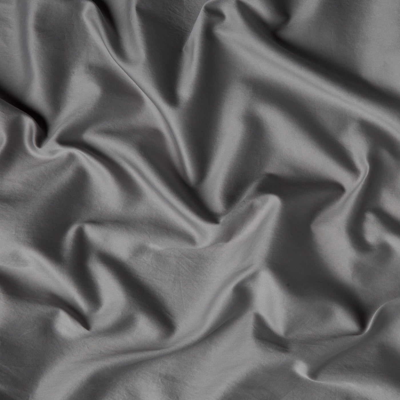 Close-up of Bella Notte Bria fitted sheet fabric showing smooth drape and soft folds.
