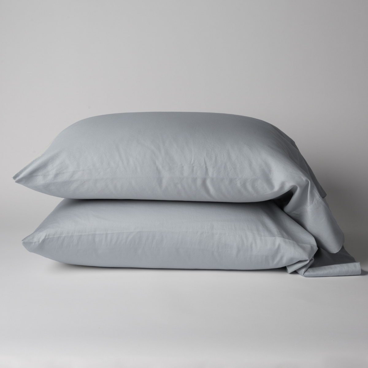 Pair of Bella Notte Bria pillowcases in Cloud, neatly stacked against a neutral background.