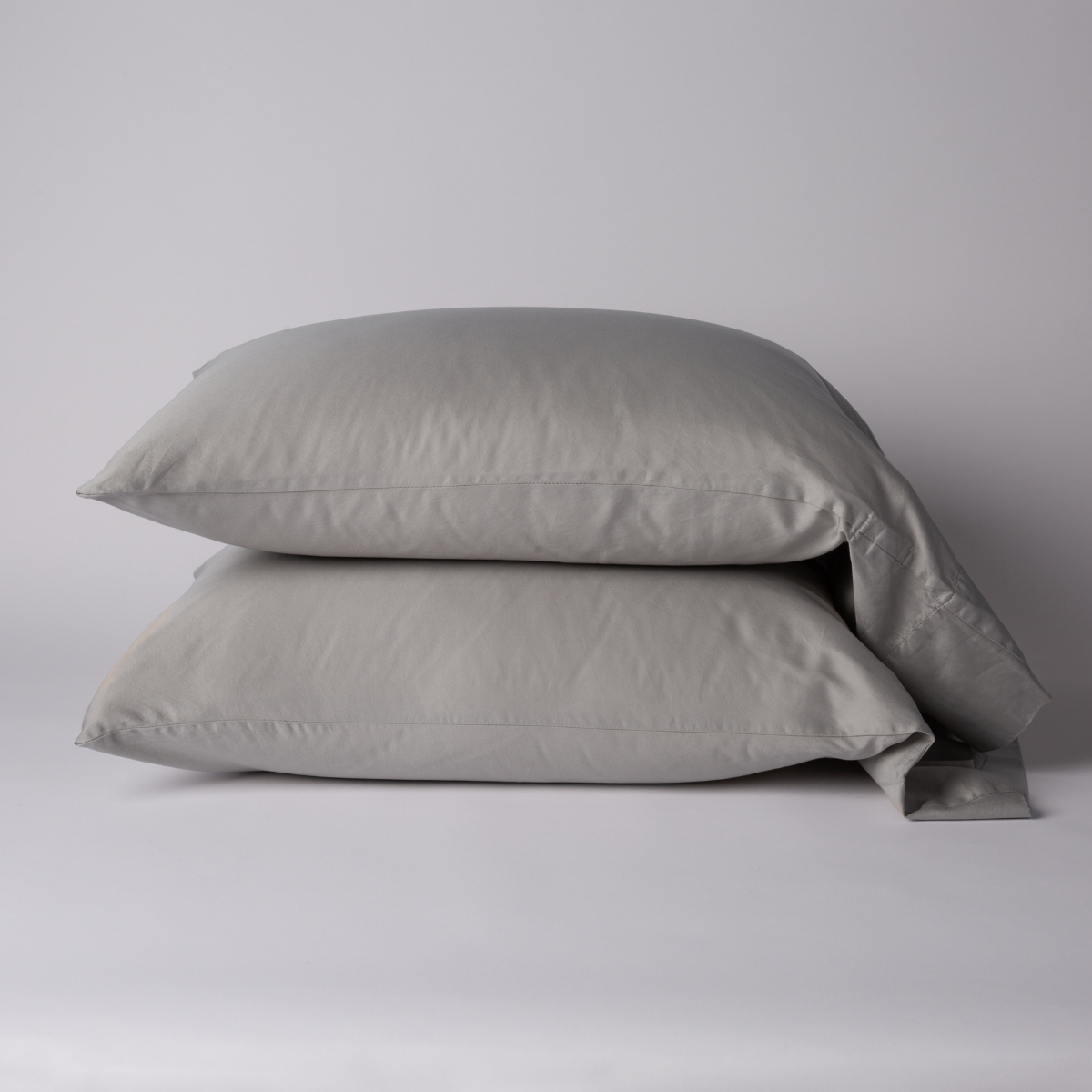 Two stacked Fog Bella Notte Bria pillowcases against a soft grey background.