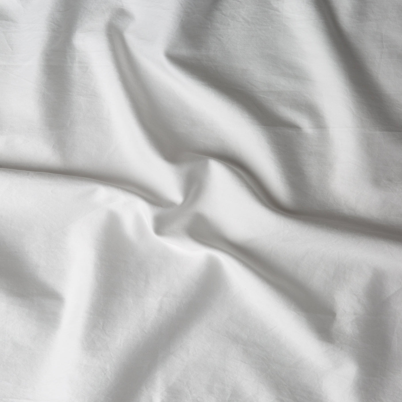 Close-up of Winter White Bella Notte Bria duvet cover showing soft linen fabric drape and texture.
