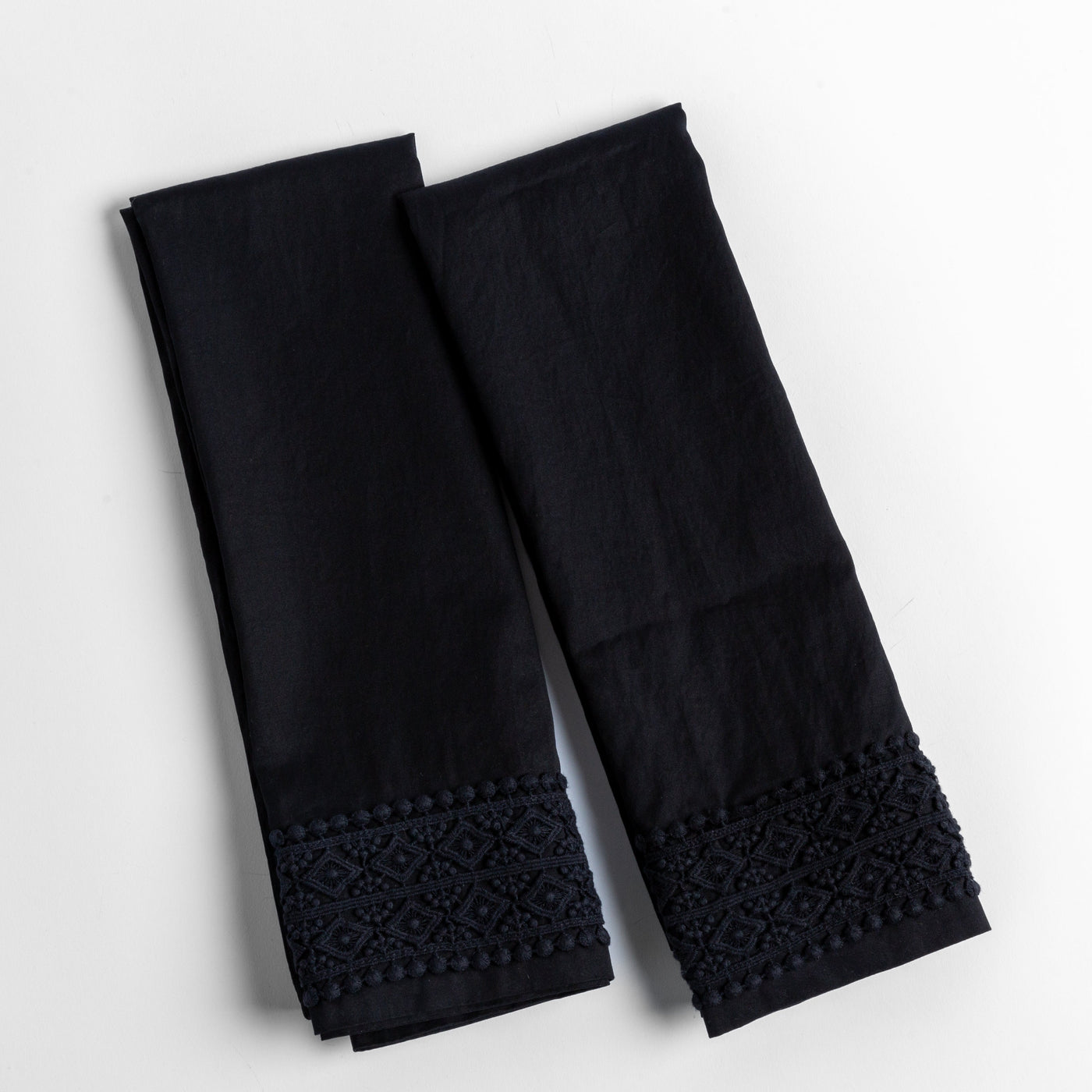 Corvino pillowcase pair showing intricate lace hem trim detail against white background.