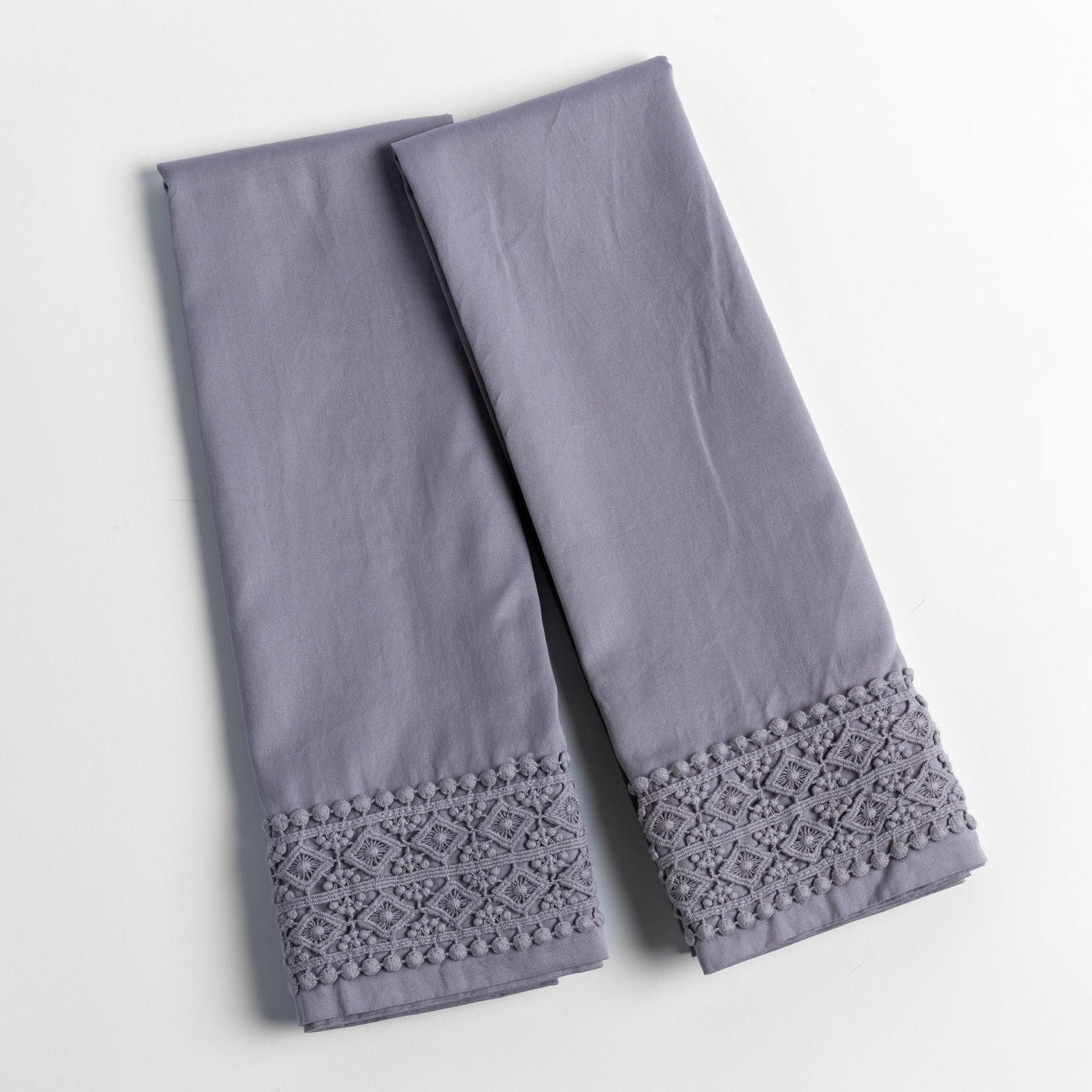 Pair of French Lavender pillowcases with tonal geometric lace cuff trim, flat lay view.