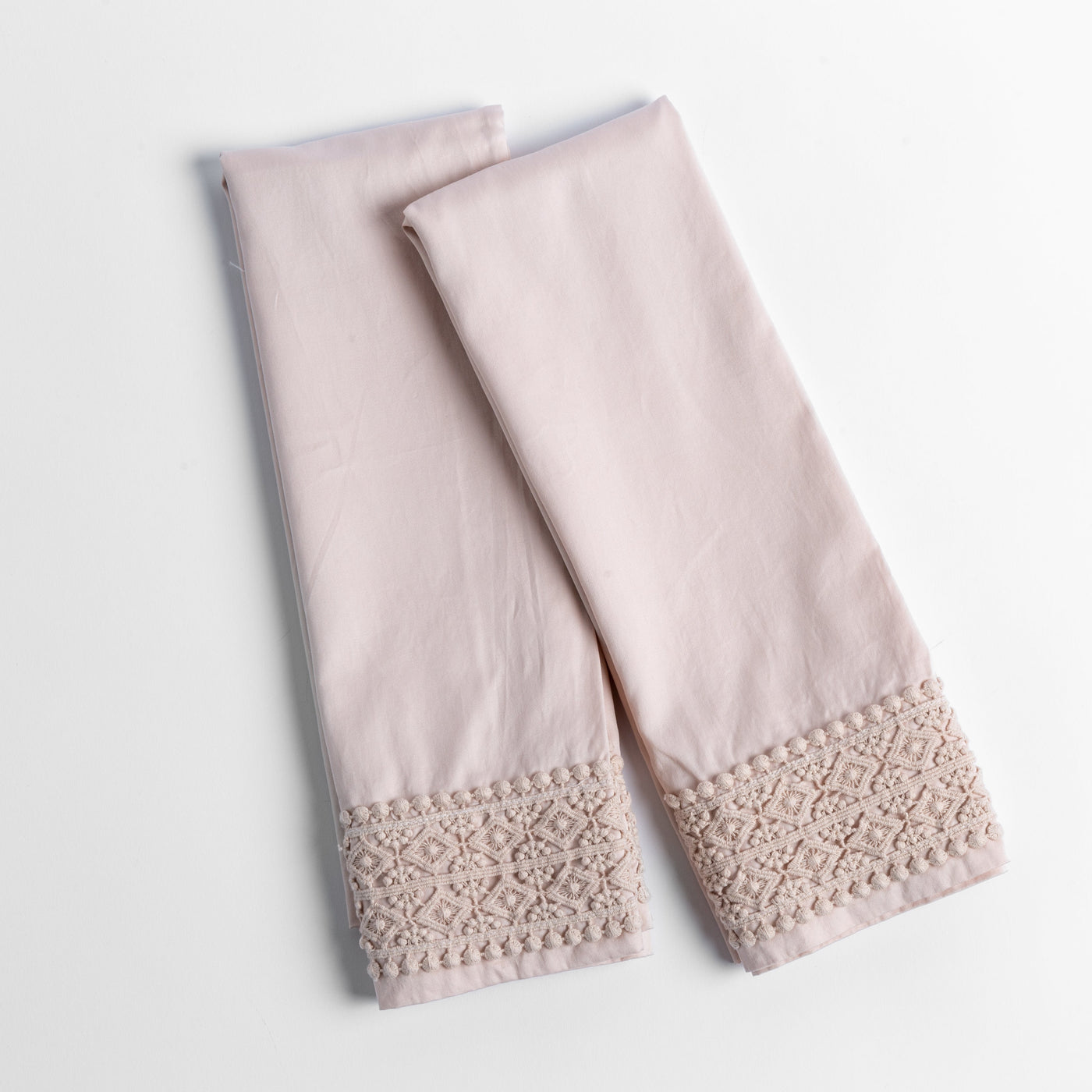 Bria pillowcase pair in Pearl, showing delicate lace crochet trim detail at hem.