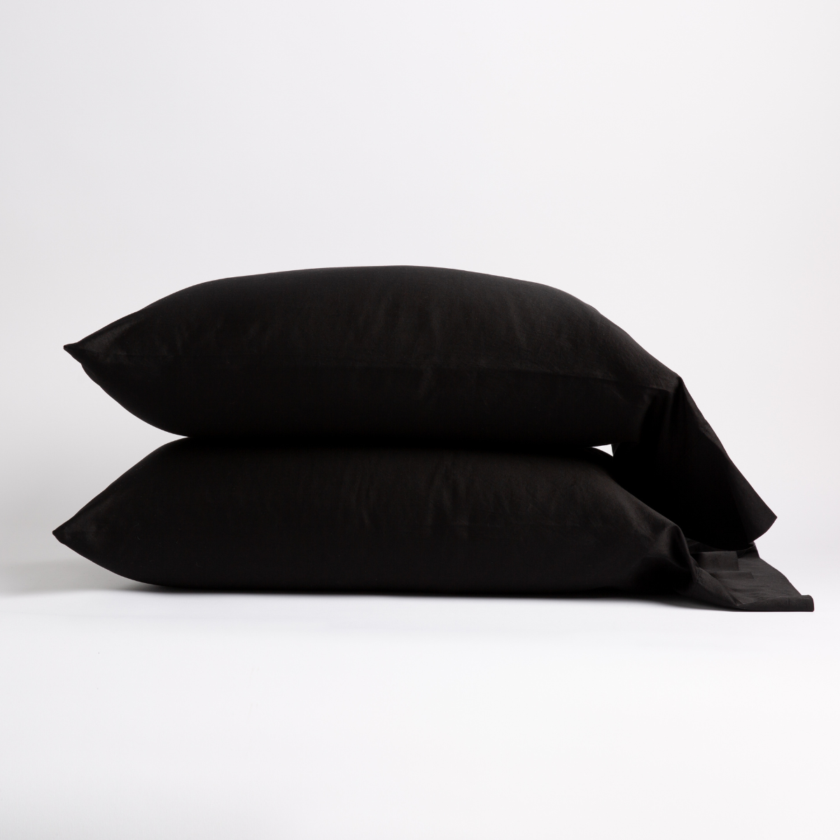 Two Bella Notte Bria pillowcases stacked in Corvino, showing smooth fabric and envelope closure detail.