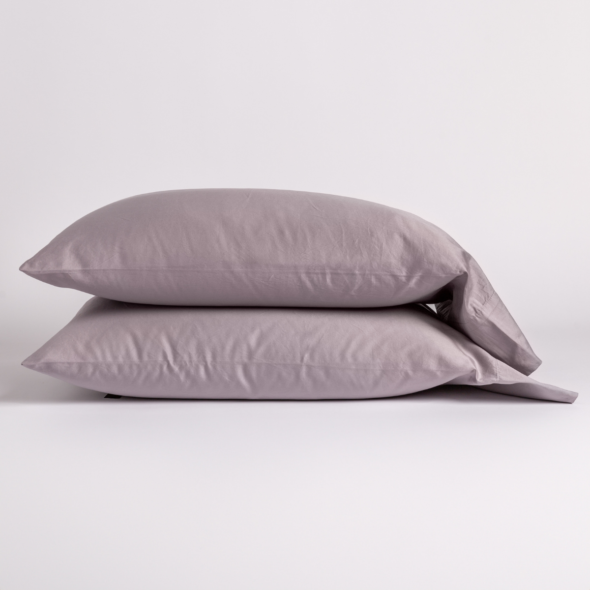 Stacked pair of Bella Notte Bria pillowcases in French Lavender on a neutral background.