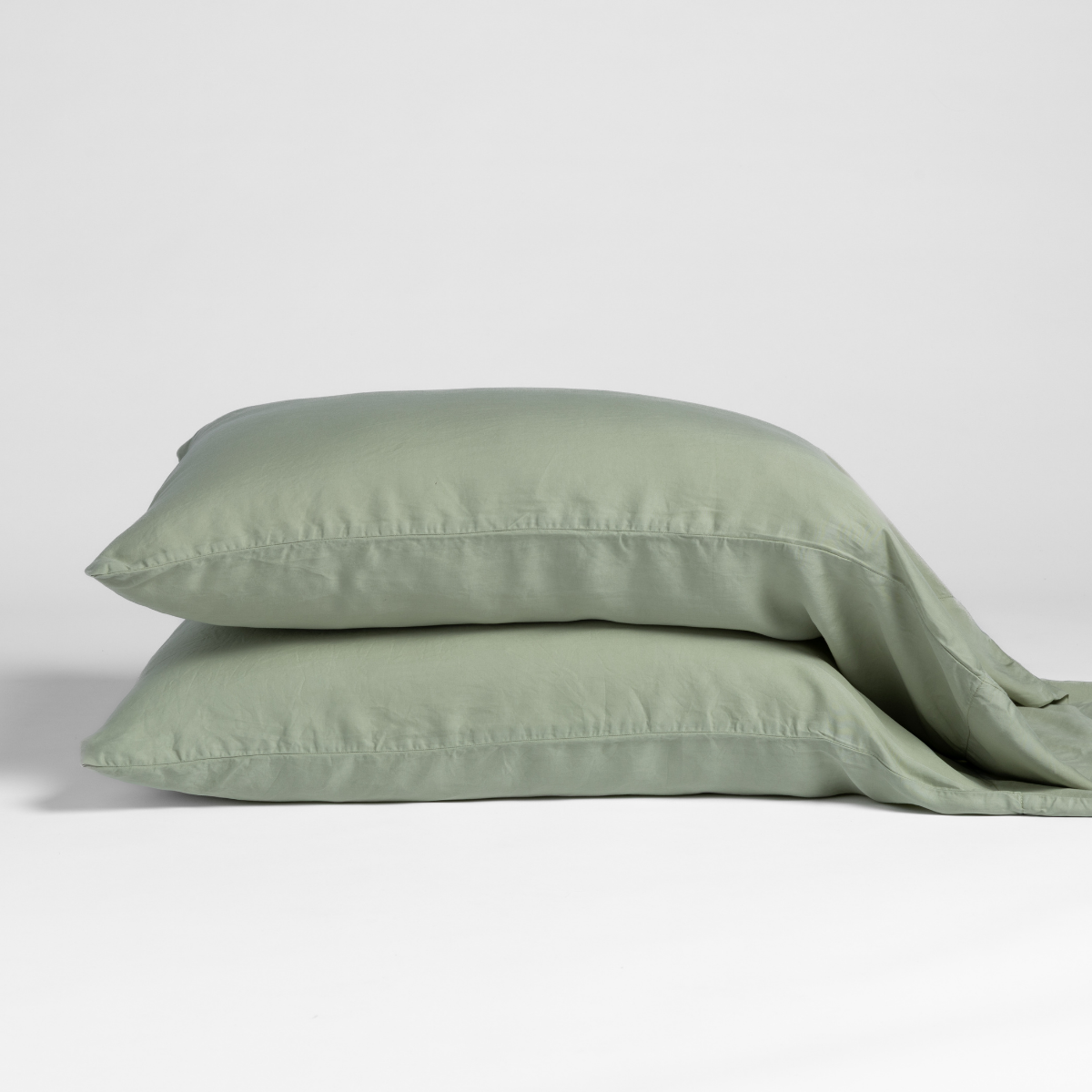 Two Desert Sage Bella Notte Bria pillowcases stacked, showing relaxed linen texture.