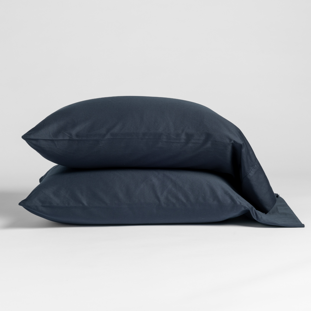 Two Slate Bella Notte Bria pillowcases stacked, showing smooth sateen finish and envelope closure.