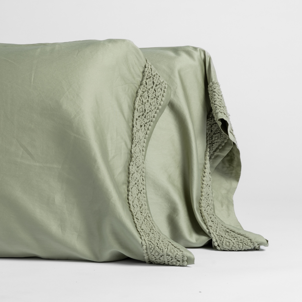 Desert Sage pillowcase edge detail showing crochet lace trim against soft cotton fabric.