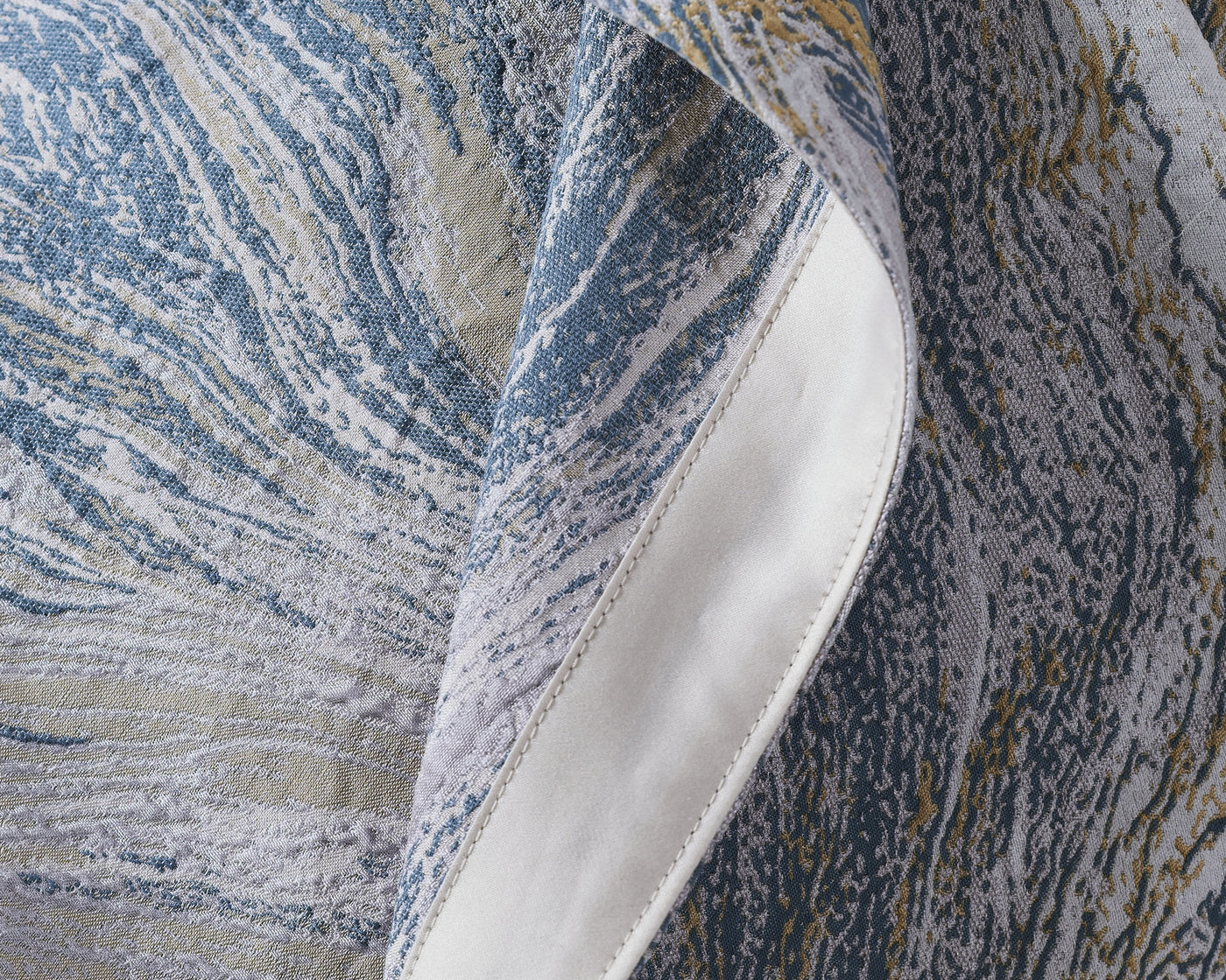 Close-up of a textured fabric with blue and beige patterns
