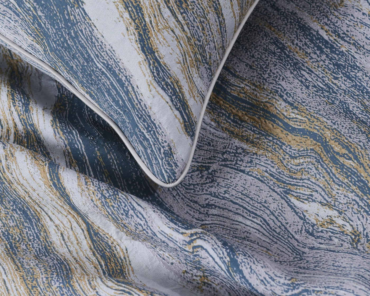 Close-up of a textured fabric with blue and gold patterns