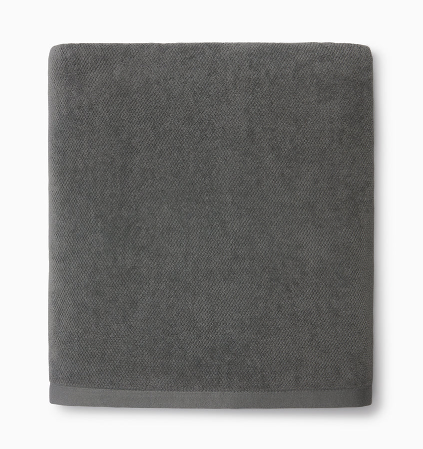 Sferra Canedo Nuovo bath towel folded in graphite cotton terry with woven border.