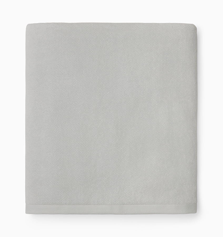 Close-up of folded silver Sferra Canedo Nuovo bath towel showing subtle woven texture.
