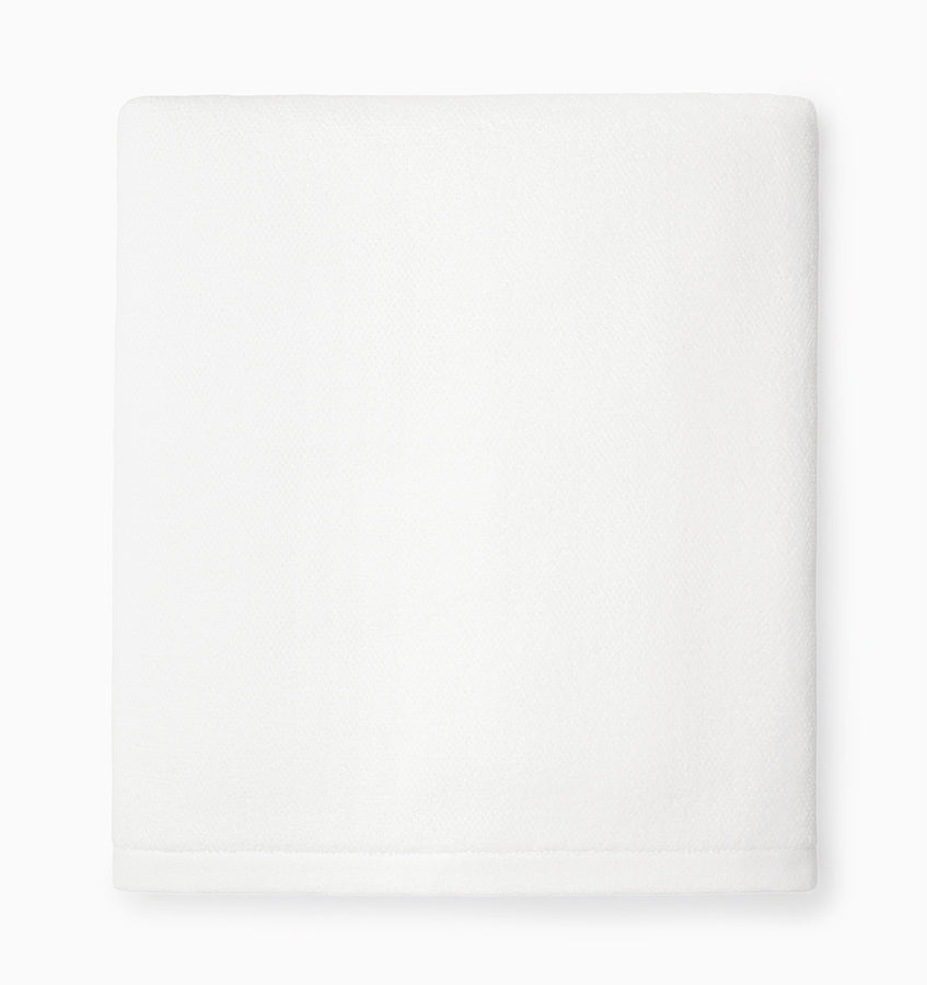 Close-up of folded white Sferra Canedo Nuovo bath towel showing smooth cotton surface.