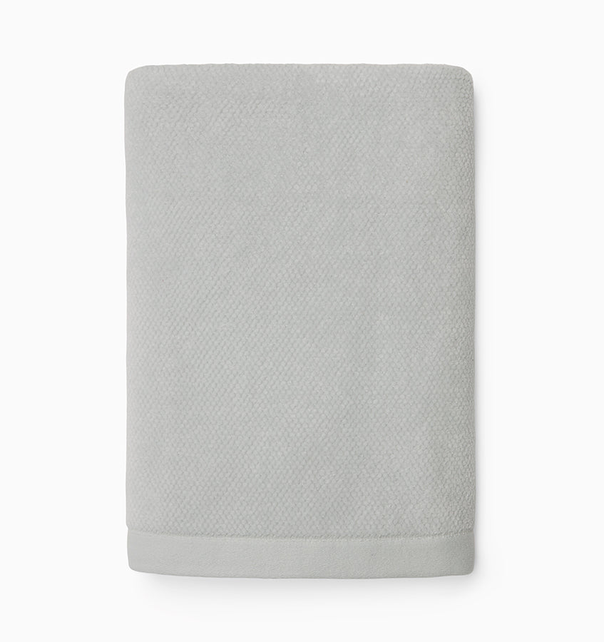 Folded silver Sferra Canedo Nuovo hand towel showing textured diamond weave surface.