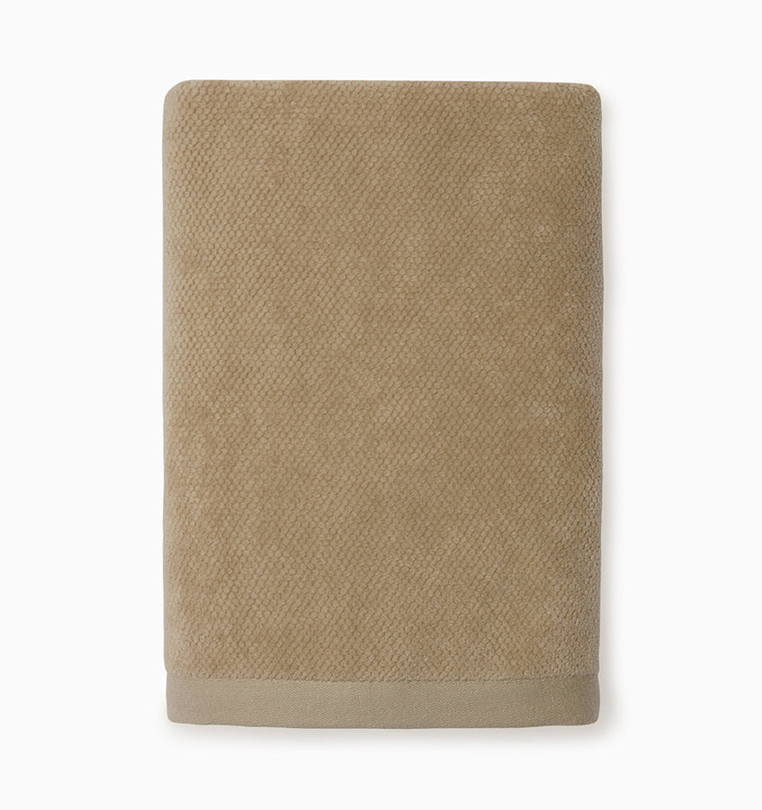 Close-up of folded Canedo Nuovo hand towel in taupe with textured cotton weave and border detail.