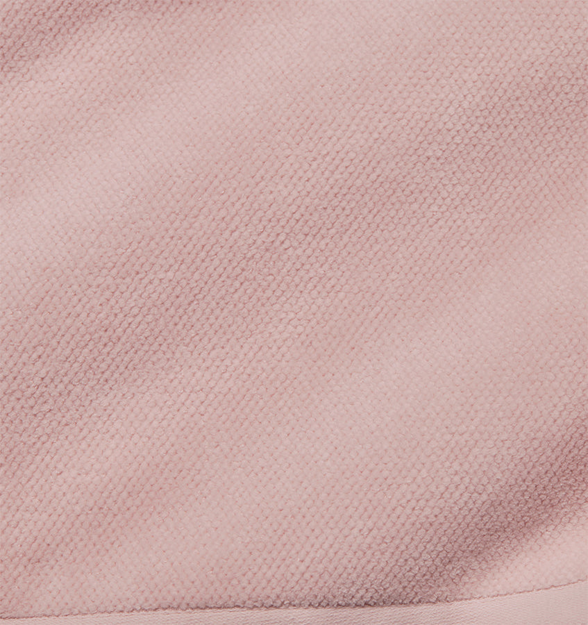 Close-up of blush pink woven cotton texture on the Canedo Nuovo tub mat.