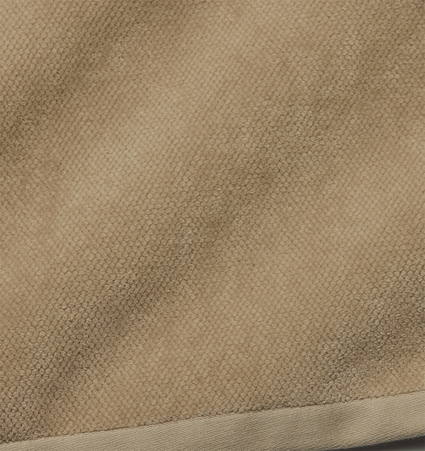 Close-up of Sferra Canedo Nuovo tub mat showing taupe textured cotton weave and border detail.