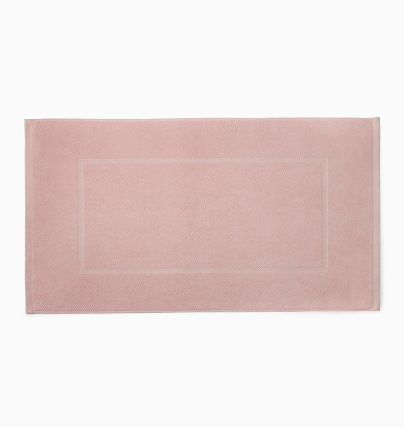 Sferra Canedo Nuovo tub mat in blush, flat lay showing tonal woven border detail.