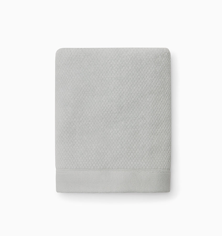 Sferra Canedo Nuovo washcloth in silver, folded flat showing textured weave.
