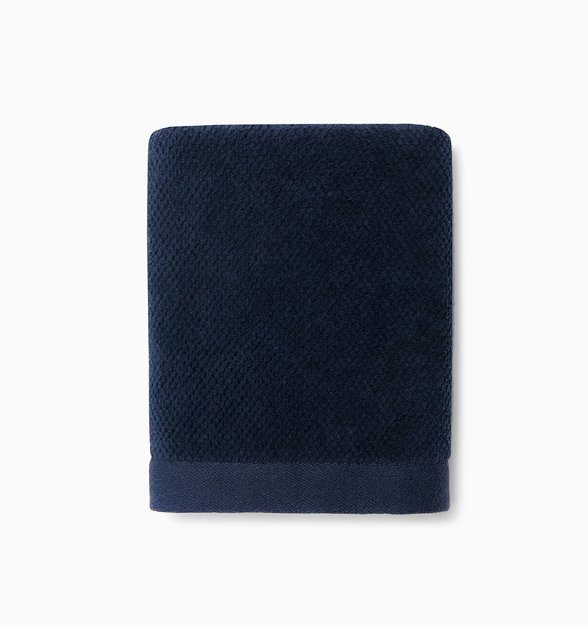 Close-up of Sferra Canedo Nuovo washcloth folded flat in midnight navy.
