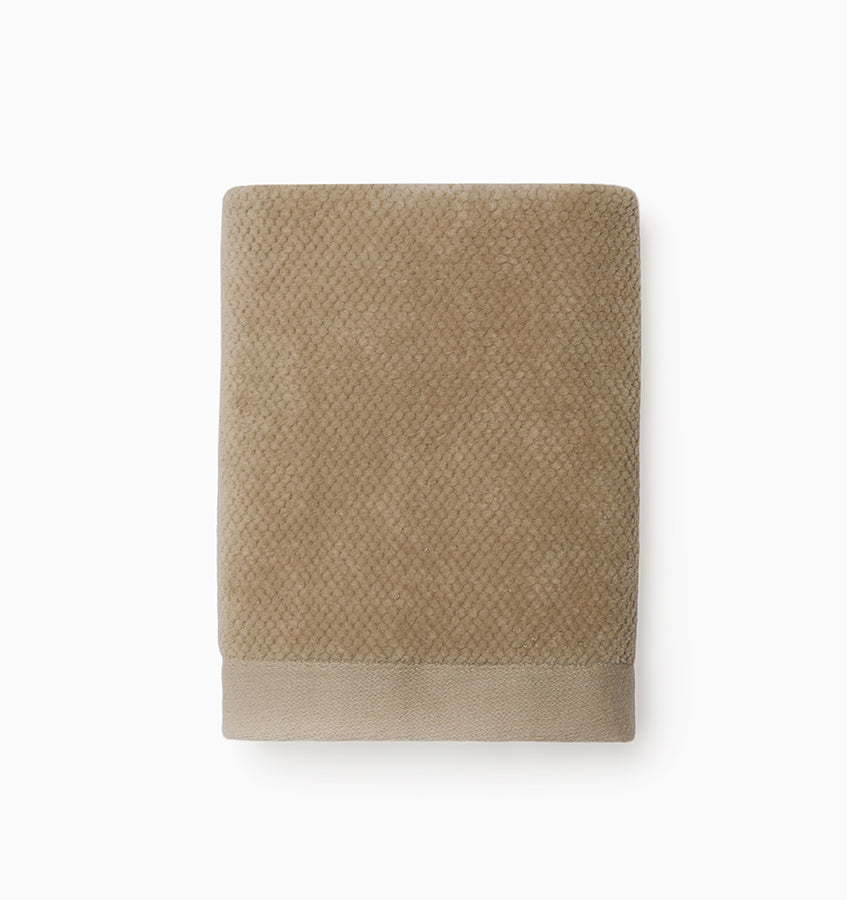 Close-up of Sferra Canedo Nuovo washcloth in taupe with textured terry weave and woven border.