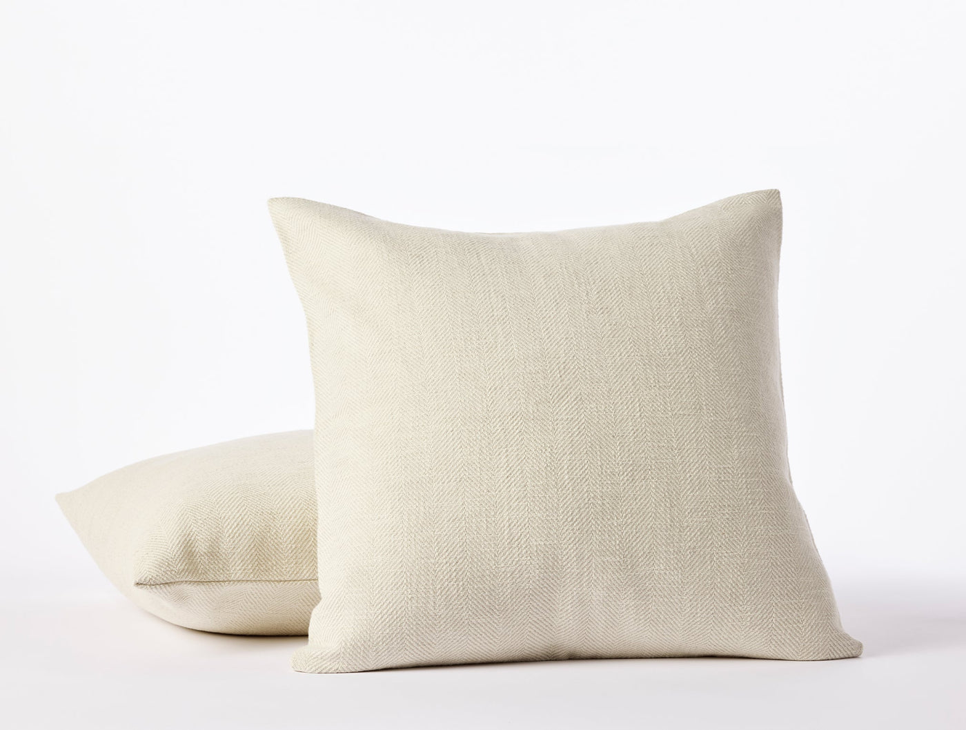 Two Coyuchi Canyon pillow covers stacked, natural linen weave texture visible in undyed ivory.