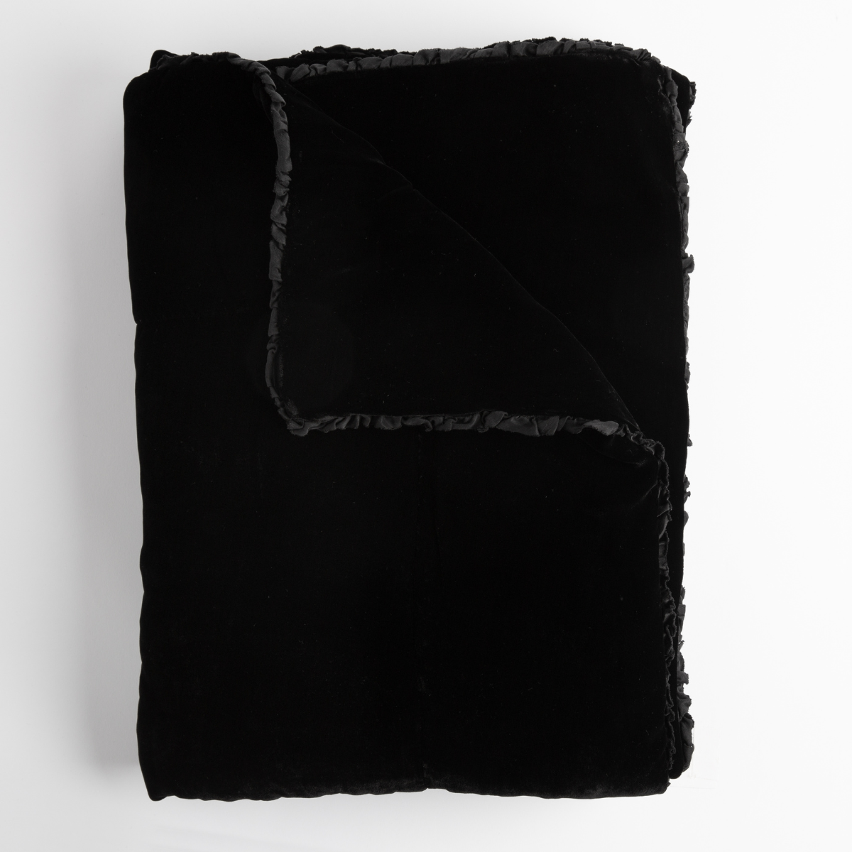 Bella Notte Carmen blanket in Corvino, folded flat showing velvet face and ruffled trim detail.