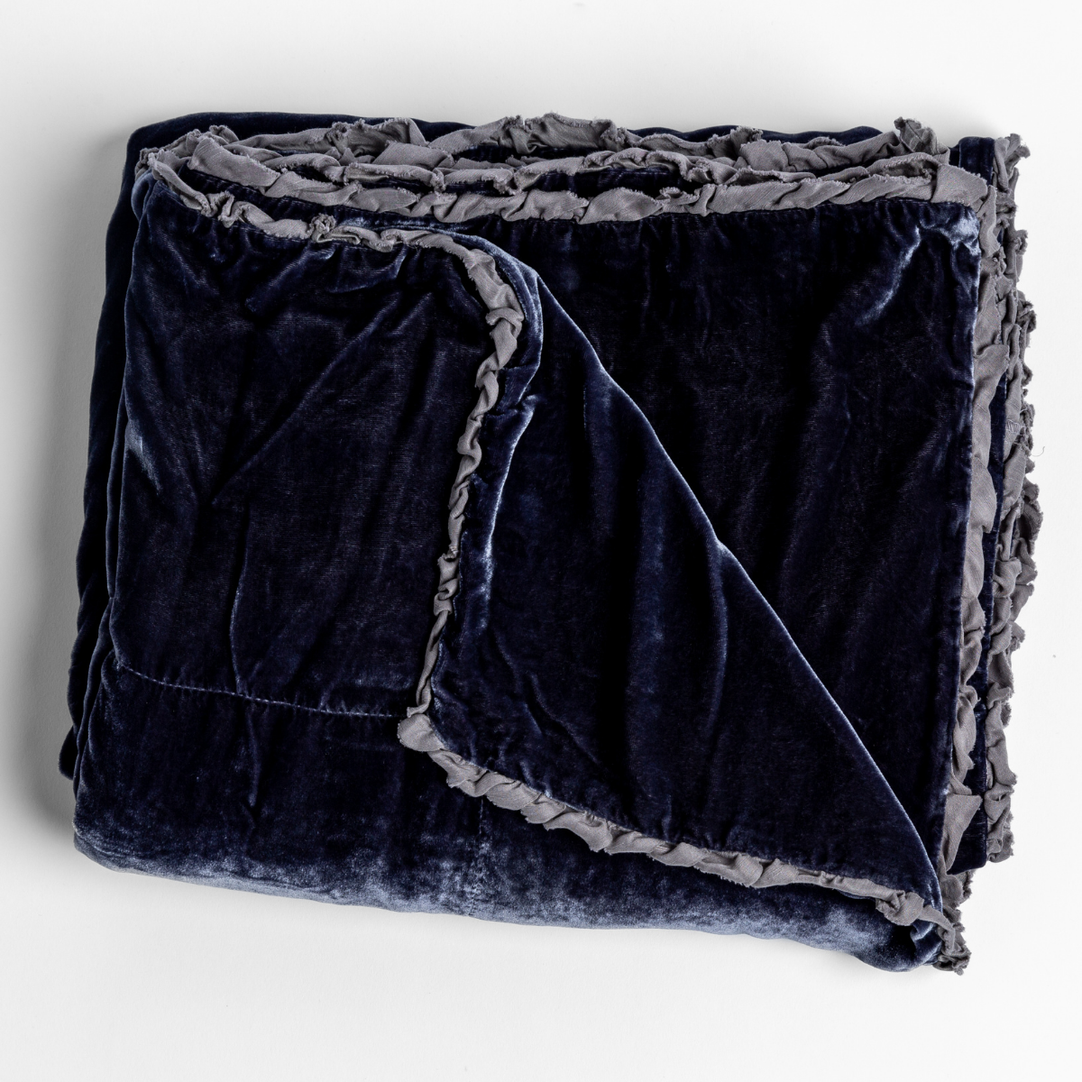 Folded French Lavender velvet blanket showing ruffle trim detail and rich fabric sheen.