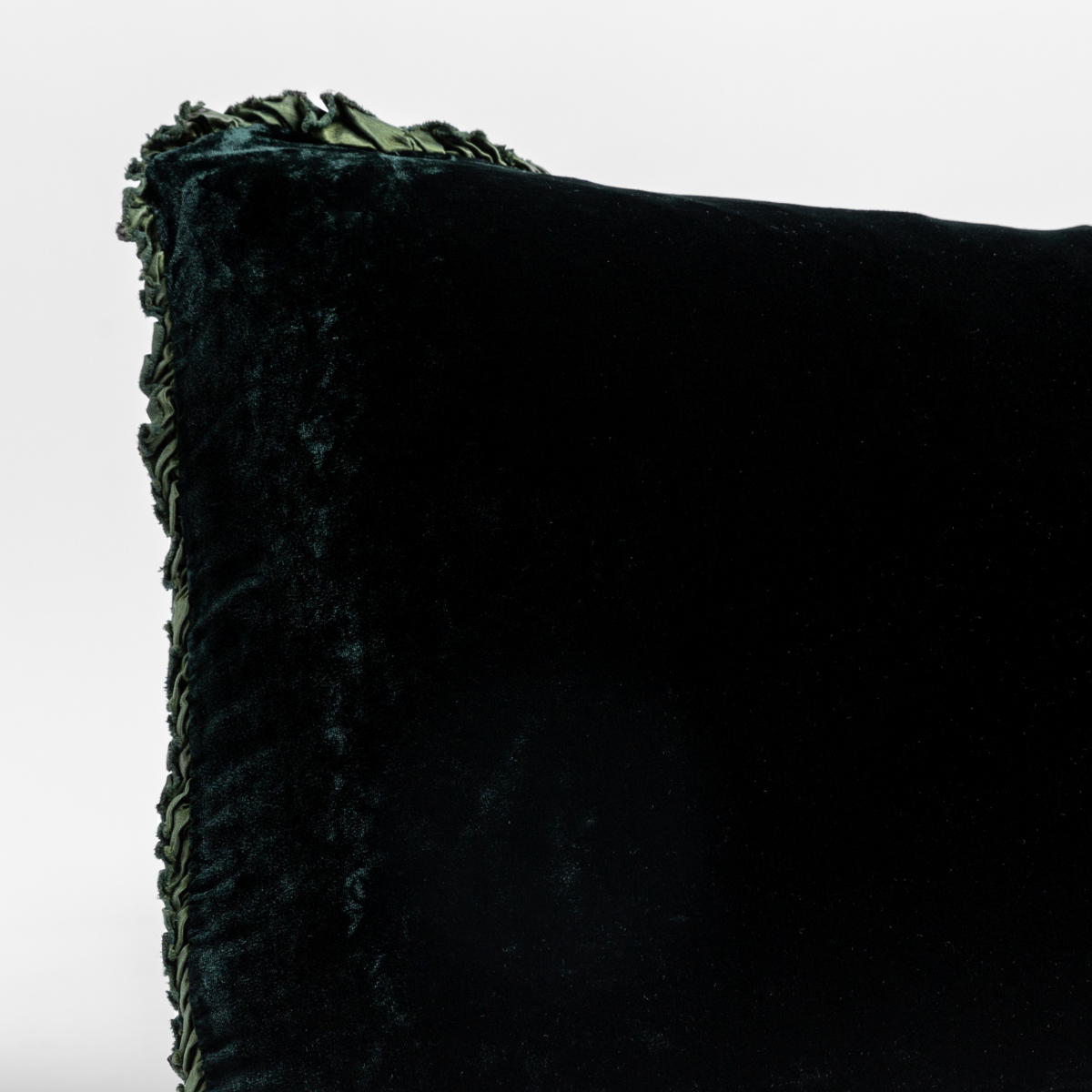 Close-up of Juniper velvet sham corner with ruffled trim detail.
