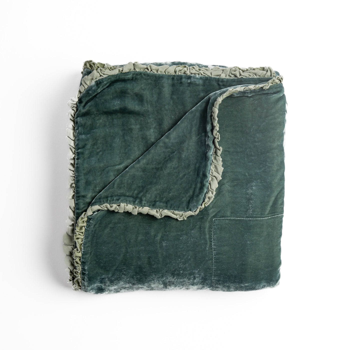 Eucalyptus velvet blanket folded to show fringe trim detail and corner.
