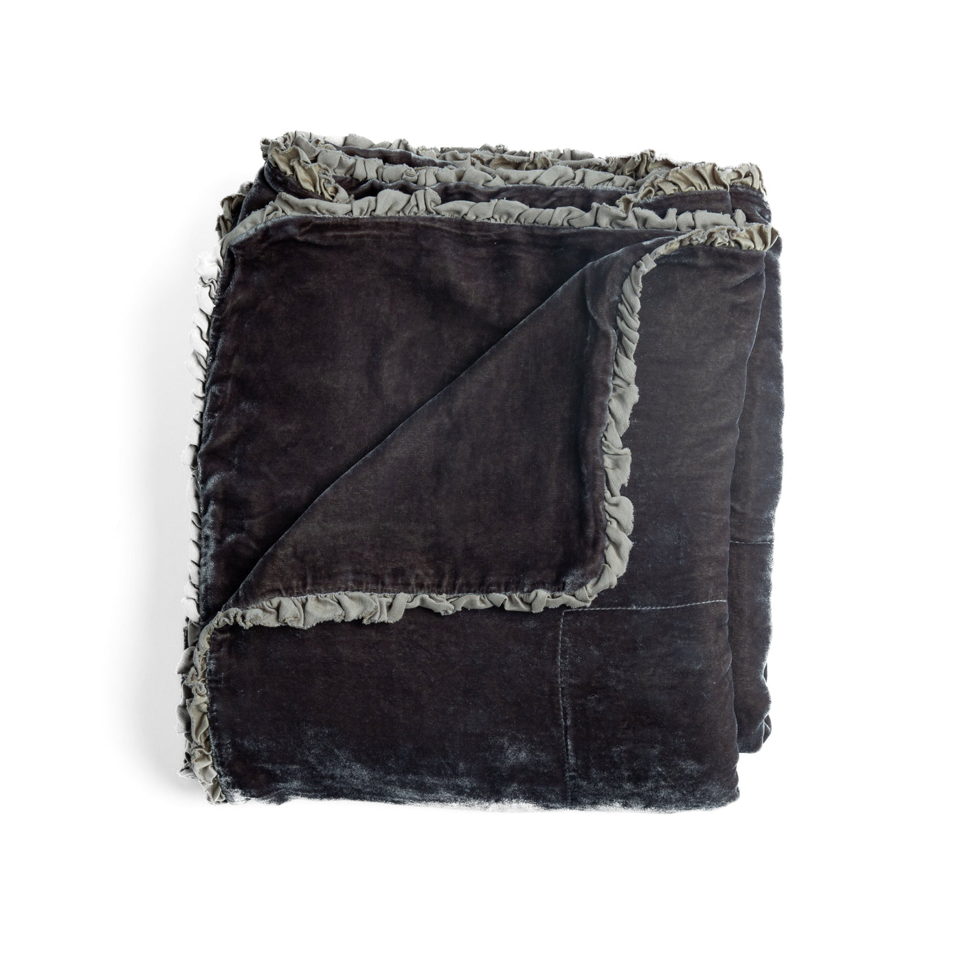 Folded charcoal velvet blanket with ruffled trim, corner turned back to show texture.