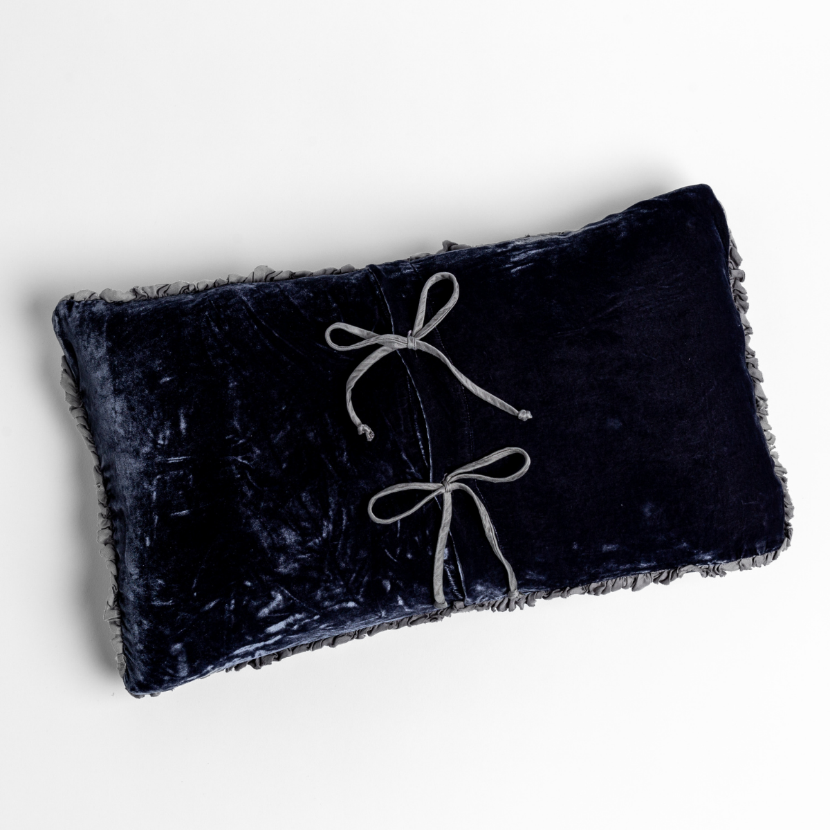 French Lavender velvet lumbar pillow with fringe trim and two silver ribbon bow details.