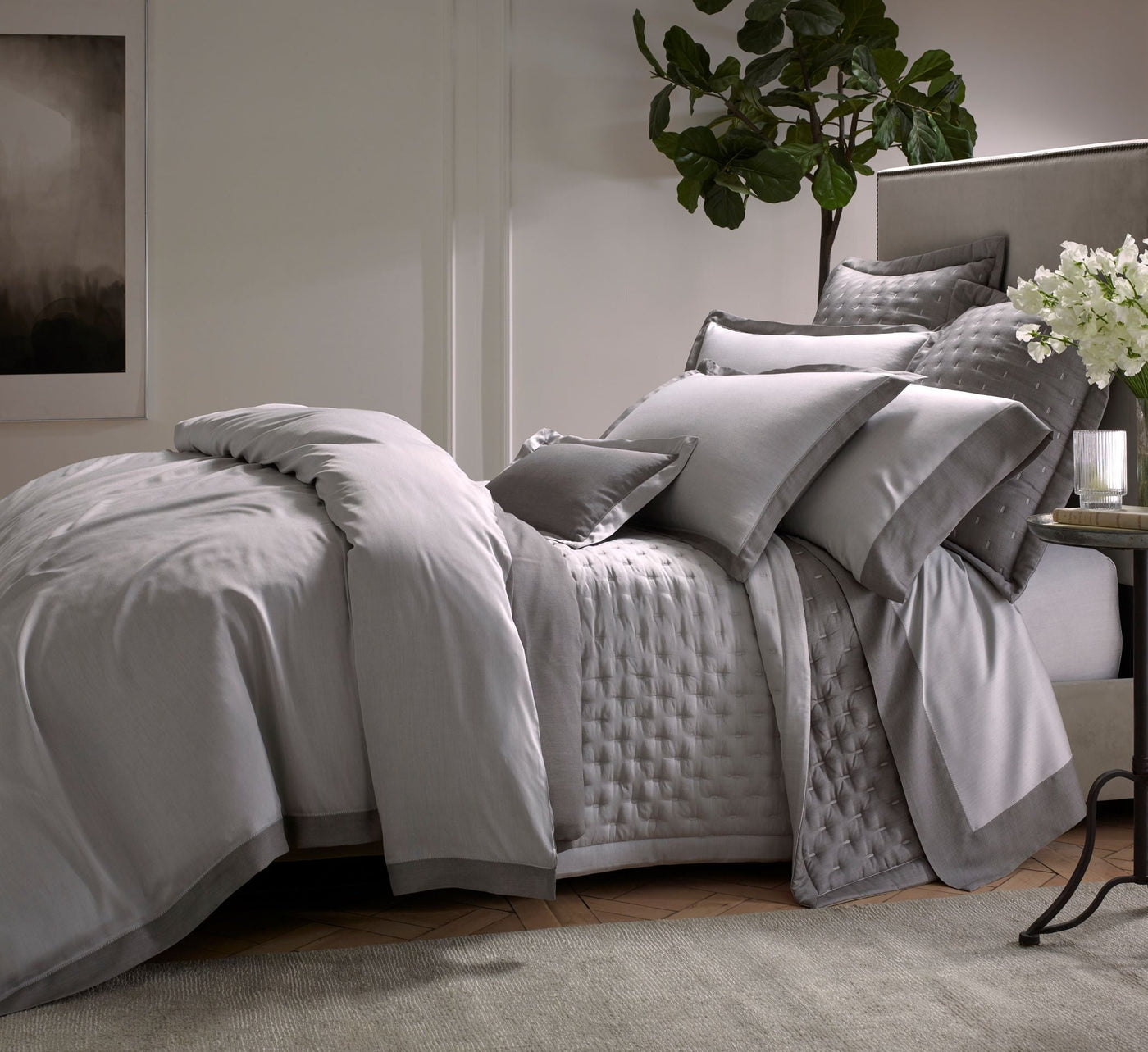 Platinum cotton bedding set with quilted coverlet and layered pillows styled on a bed.