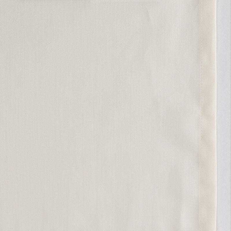 Close-up of ivory fabric with subtle woven texture and hemstitch border detail.