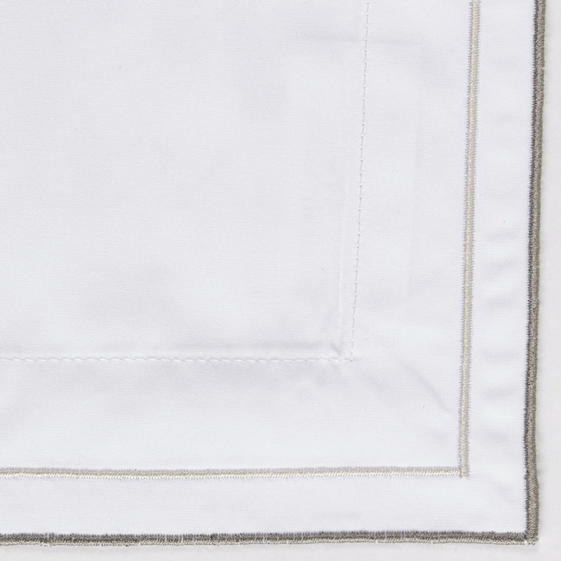 White Pillowcase with subtle grey embroidery along the edge, featuring Areo Pillowcase by Celso de Lemos available at Linen Society.