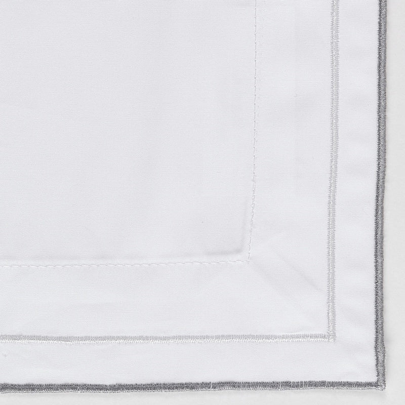White pillowcase with subtle grey stitching detail, featuring Areo Pillowcase by Celso de Lemos available at Linen Society.
