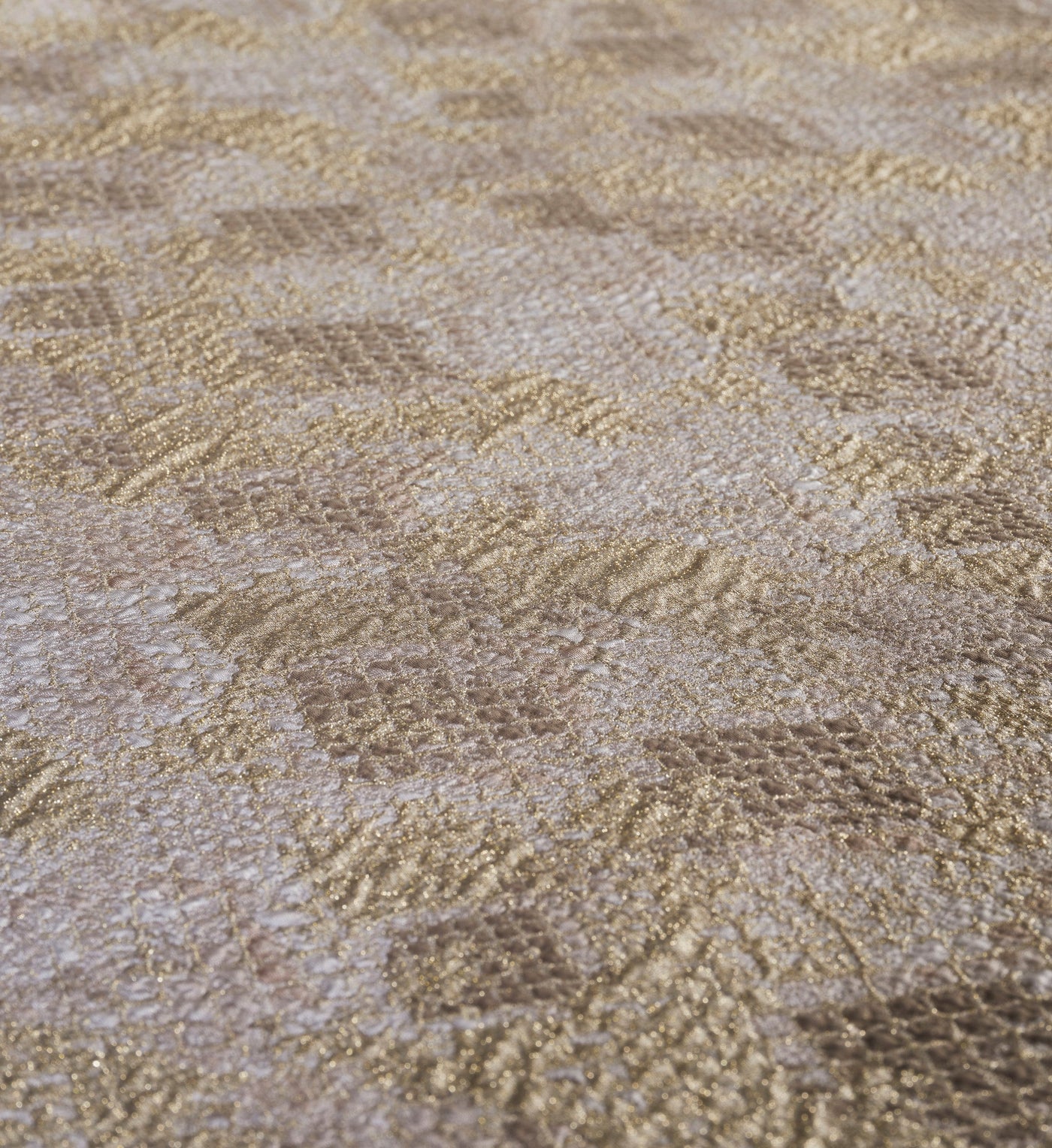 Angled close-up of champagne gold and beige textured fabric with a woven, shimmering pattern, featuring Australia Pillow Cover by Celso de Lemos available at Linen Society.