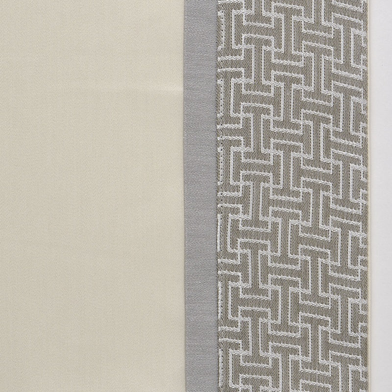 Close-up of ivory linen fabric alongside grey geometric basketweave border detail.