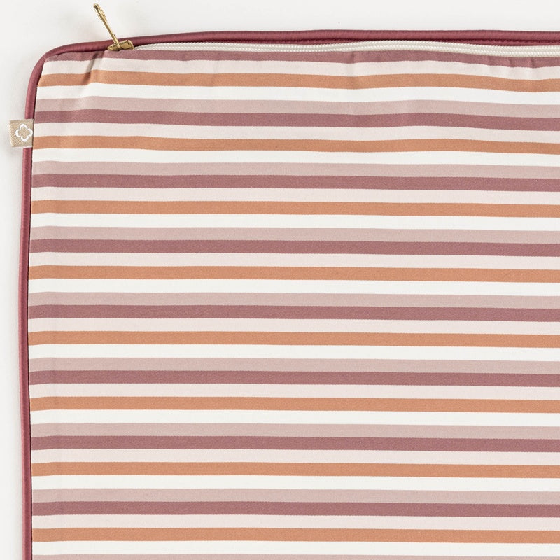 Close-up of a striped pillowcase in muted pinks, whites, and burnt orange tones, featuring the Baya Pillowcase by Celso de Lemos available at Linen Society.